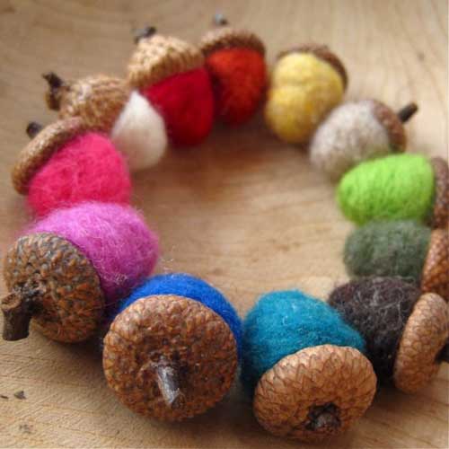 Hand felted acorns in rainbow colors.