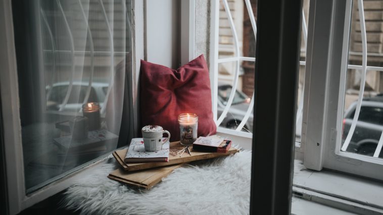 candles and tea next to window